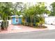 Charming blue home featuring well-manicured landscaping and a bright yellow door at 3306 E Chelsea St, Tampa, FL 33610