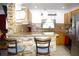 Charming kitchen featuring granite countertops, stone backsplash, and breakfast bar with pendant lighting at 3306 E Chelsea St, Tampa, FL 33610