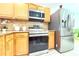 Well-lit kitchen showcasing wooden cabinets, stainless steel appliances, and ample counter space at 3306 E Chelsea St, Tampa, FL 33610
