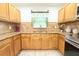 Kitchen with wood cabinets, granite countertops, stainless steel appliances and a view of the sink at 3306 E Chelsea St, Tampa, FL 33610