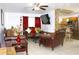Cozy living room with leather furniture, decorative accents, and an open view to the kitchen at 3306 E Chelsea St, Tampa, FL 33610
