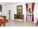 Open-concept living room featuring a mirror, flower display, and interior doorway with burgundy curtains at 3306 E Chelsea St, Tampa, FL 33610