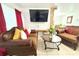 Inviting living room featuring comfortable seating, a large TV, and warm decor at 3306 E Chelsea St, Tampa, FL 33610