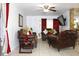 Comfortable living room featuring tile flooring, a ceiling fan, and stone accents at 3306 E Chelsea St, Tampa, FL 33610