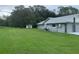 Spacious backyard with lush green lawn and shed, perfect for outdoor activities at 35209 Dolphin Lake Dr, Zephyrhills, FL 33541