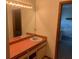 A bathroom offers a spacious vanity area and a tile floor at 35209 Dolphin Lake Dr, Zephyrhills, FL 33541