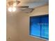 A bedroom features a ceiling fan and a bright window view at 35209 Dolphin Lake Dr, Zephyrhills, FL 33541