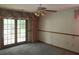 A bedroom with french doors leads to a backyard view at 35209 Dolphin Lake Dr, Zephyrhills, FL 33541
