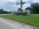 Beautiful front view of home with a well-manicured front yard and a two-car garage at 35209 Dolphin Lake Dr, Zephyrhills, FL 33541