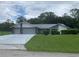 Charming single-story home with a large front lawn and a two-car garage at 35209 Dolphin Lake Dr, Zephyrhills, FL 33541