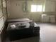 Spacious garage with stacked materials, window and storage cabinets, perfect for projects and parking at 35209 Dolphin Lake Dr, Zephyrhills, FL 33541