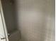 Tiled walk-in shower with built-in seating at 35209 Dolphin Lake Dr, Zephyrhills, FL 33541