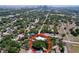 Aerial view of property nestled among trees with city view in the background at 3706 N Ola Ave, Tampa, FL 33603