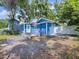 Backyard view of a blue house with a small deck and a privacy fence at 3706 N Ola Ave, Tampa, FL 33603