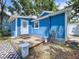 Backyard view of a blue house featuring a wooden deck and white trim at 3706 N Ola Ave, Tampa, FL 33603
