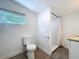 Bathroom featuring a shower, toilet, wood look flooring, and a window for natural light at 3706 N Ola Ave, Tampa, FL 33603