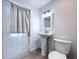 Bathroom with white pedestal sink, toilet and door to the exterior at 3706 N Ola Ave, Tampa, FL 33603
