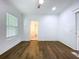 Bedroom with hardwood floors, window with blinds, and bathroom access at 3706 N Ola Ave, Tampa, FL 33603