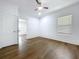 Bedroom with hardwood floors, white trim, ceiling fan, and a large window at 3706 N Ola Ave, Tampa, FL 33603