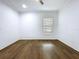 Spacious bedroom featuring hardwood floors and a window at 3706 N Ola Ave, Tampa, FL 33603