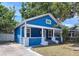 Stylish blue home with a white trim, a welcoming front porch, and fresh landscaping at 3706 N Ola Ave, Tampa, FL 33603