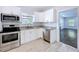Modern kitchen featuring white cabinets, granite countertops, and stainless steel appliances at 3706 N Ola Ave, Tampa, FL 33603