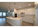 Modern kitchen with stainless appliances, island, and sleek white cabinetry at 404 N Westland St # 1, Tampa, FL 33609