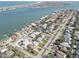 Beautiful aerial view showcasing the homes with waterfront access and the city in the distance at 413 8Th N Ave, Tierra Verde, FL 33715