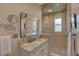 Elegant bathroom featuring a glass shower, granite countertops, and decorative ceiling at 413 8Th N Ave, Tierra Verde, FL 33715