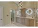 Bathroom featuring double sink vanity, decorative lighting fixture, and a separate toilet room at 413 8Th N Ave, Tierra Verde, FL 33715