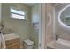 Powder room featuring toilet, sink, neutral walls, and a peek at the rest of the bathroom at 413 8Th N Ave, Tierra Verde, FL 33715