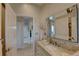 Stylish bathroom with a granite countertop, large mirror, and neutral color scheme at 413 8Th N Ave, Tierra Verde, FL 33715