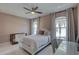 Cozy bedroom with neutral colors, large windows, and a ceiling fan at 413 8Th N Ave, Tierra Verde, FL 33715