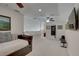 Upstairs bonus room with cozy daybed, Tonal home gym, and neutral carpeting at 413 8Th N Ave, Tierra Verde, FL 33715