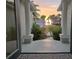 Inviting foyer view with sunset through the doors, palm trees, and lush landscape at 413 8Th N Ave, Tierra Verde, FL 33715