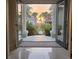 Inviting foyer view with sunset through the doors, palm trees, and lush landscape at 413 8Th N Ave, Tierra Verde, FL 33715