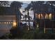 Charming street view with palm trees framing the houses and waterfront at twilight at 413 8Th N Ave, Tierra Verde, FL 33715
