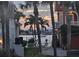 Charming street view with palm trees framing the houses and waterfront at sunset at 413 8Th N Ave, Tierra Verde, FL 33715