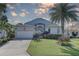 Charming single-Gathering home featuring a well-manicured lawn, mature palms, and an attached two-car garage at 413 8Th N Ave, Tierra Verde, FL 33715