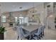 Open kitchen and dining area with chandeliers and a stainless steel hood above the stove at 413 8Th N Ave, Tierra Verde, FL 33715