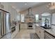 Elegant kitchen with granite countertops, stainless steel appliances, vaulted ceiling, and custom cabinetry at 413 8Th N Ave, Tierra Verde, FL 33715