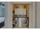 Laundry room featuring large capacity stainless steel washer and dryer and white cabinets at 413 8Th N Ave, Tierra Verde, FL 33715
