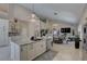Open-concept living space with an island kitchen, cathedral ceiling, chandeliers, and spiral staircase at 413 8Th N Ave, Tierra Verde, FL 33715
