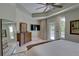 Main bedroom features neutral walls, en suite bathroom, walk-out to the pool, and ceiling fan at 413 8Th N Ave, Tierra Verde, FL 33715