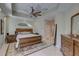Main bedroom featuring neutral walls, ceiling fan, a glimpse into en suite, and natural light at 413 8Th N Ave, Tierra Verde, FL 33715