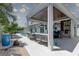 Covered outdoor kitchen featuring a bar, grill, and seating near the pool at 413 8Th N Ave, Tierra Verde, FL 33715