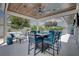 Covered outdoor kitchen and bar area with seating and view of pool at 413 8Th N Ave, Tierra Verde, FL 33715