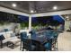 Outdoor kitchen with grill, bar, and seating near pool with modern furnishings at 413 8Th N Ave, Tierra Verde, FL 33715