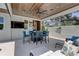 Outdoor kitchen featuring a grill, wood ceiling, and bar seating at 413 8Th N Ave, Tierra Verde, FL 33715