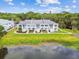 Overhead shot of light blue condo buildings and a pond surrounded by green trees at 4141 Dolphin Dr # 4141, Tampa, FL 33617